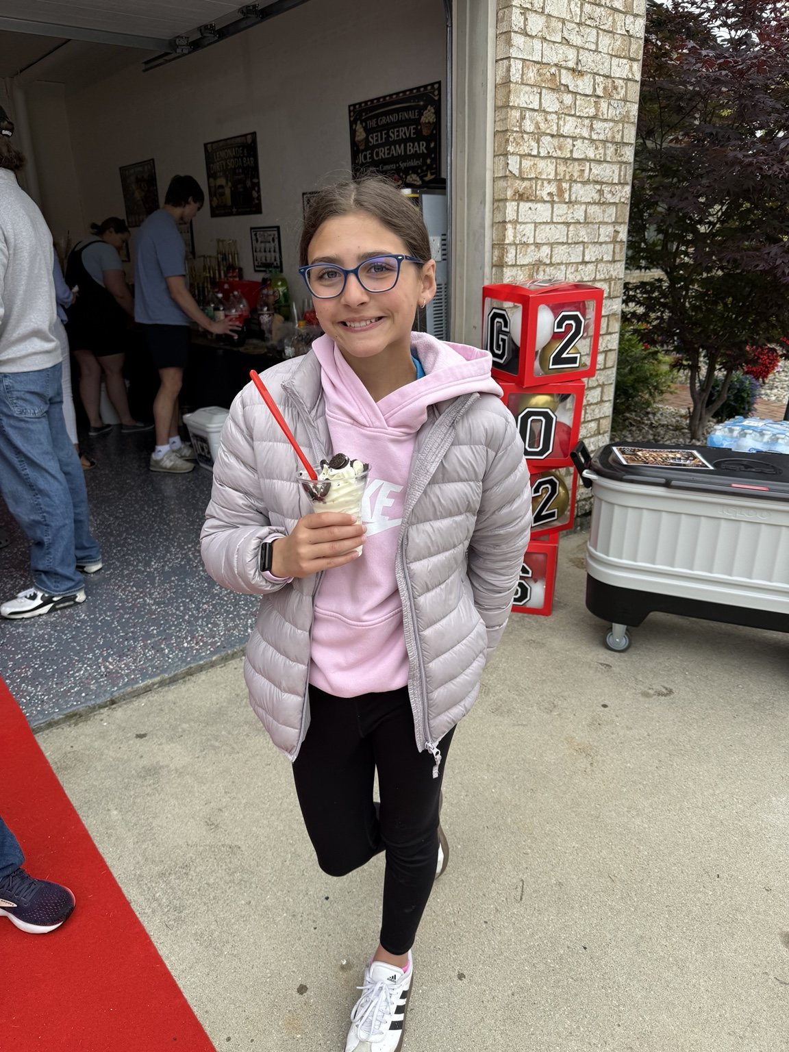 Smiling guest holding an ice cream sundae