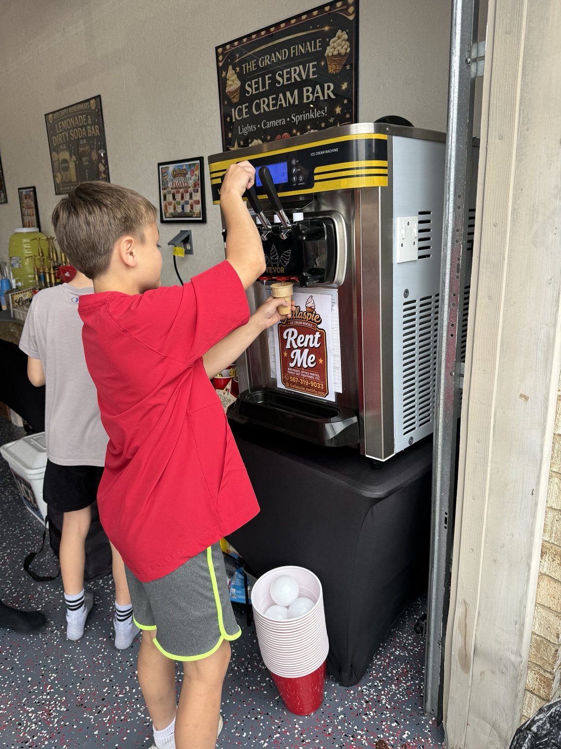 Child pulling soft serve from the machine